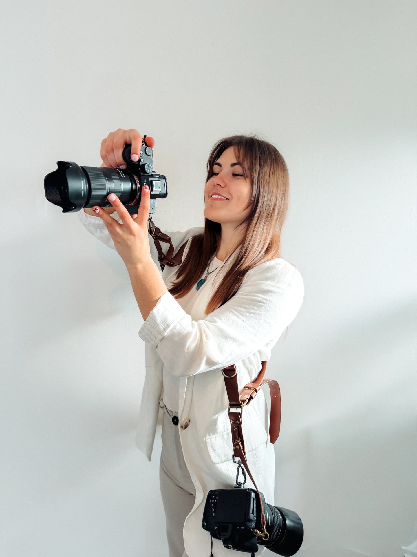 Natalia photographing with a Sony camera and leather straps